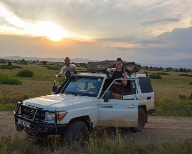 Toyota Land Cruiser 4x4 self drive car hire in Akagera National Park watching giraffes on savannah track