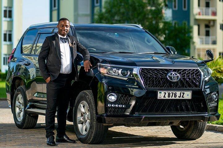 Car hire in Kigali with a driver beside a Toyota SUV